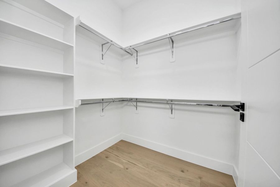 The walk-in closet in the primary bedroom/guest suite is thoughtfully designed with built-in shelving, offering abundant storage.