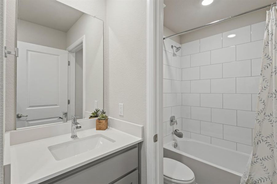 Bathroom vanity with a rectangular undermount sink, a chrome faucet, and a quartz countertop Bathroom vanity with a rectangular undermount sink, a chrome faucet, and a quartz countertop