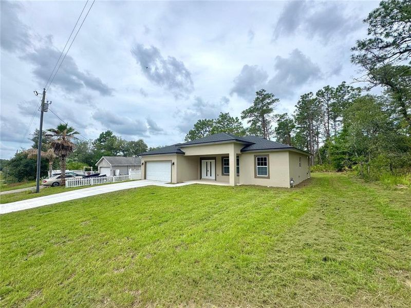 Front exterior of a new home in , Citrus Springs, FL, highlighting curb appeal (Image 1).