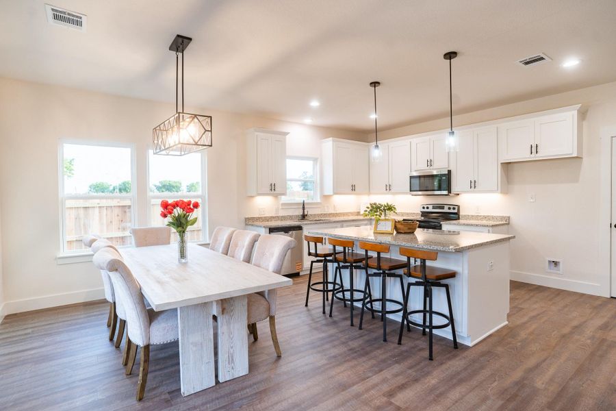 Dining space featuring baseboards, healthy amount of natural light, dark wood finished floors, and recessed lighting