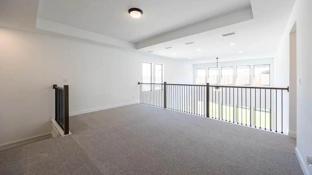 Carpeted empty room with baseboards and recessed lighting Carpeted empty room with baseboards and recessed lighting