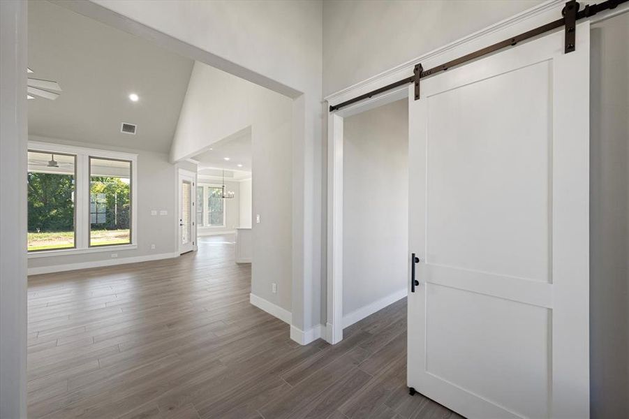 Entryway leading into living room and office behind the barn door