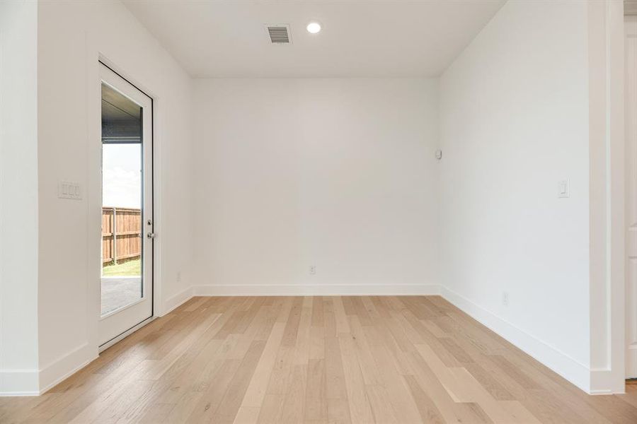 Empty room with light wood-type flooring and recessed lighting Empty room with light wood-type flooring and recessed lighting