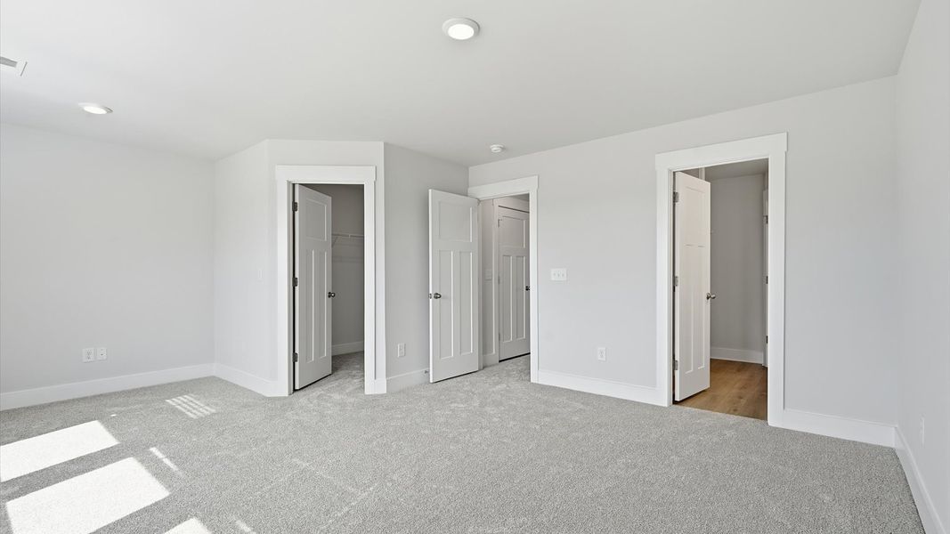 Vibrant natural light fills this exceptional primary suite with eye-catching details located near Downtown Simpsonville