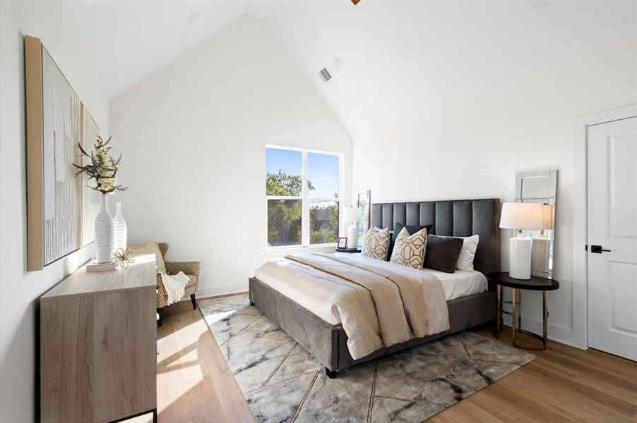 Large primary bedroom has sweeping cathedral ceilings.