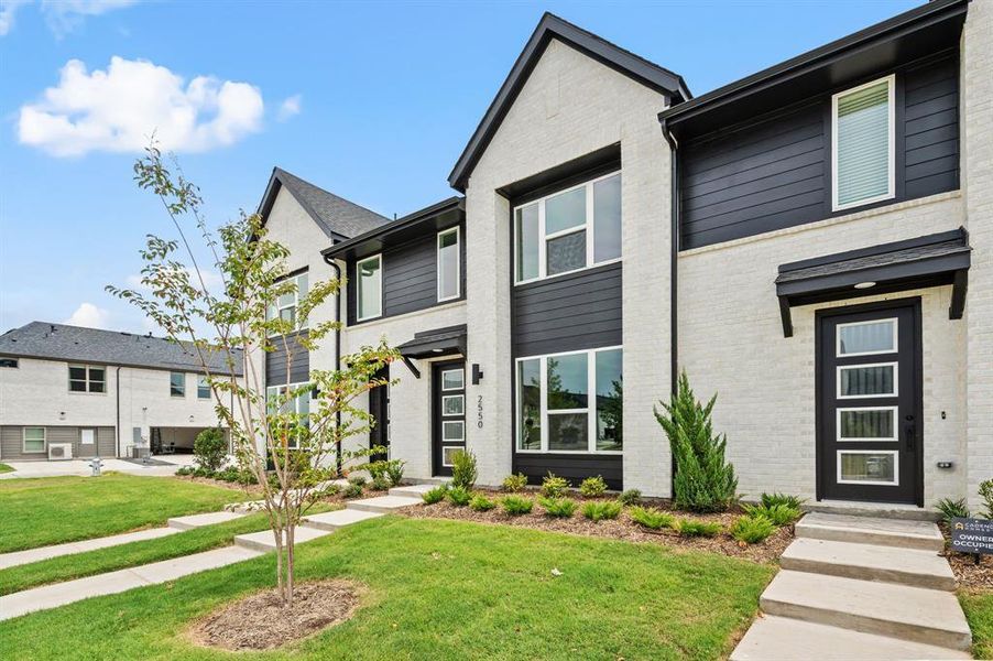 Light colored brick paired with striking dark trim create wonderful curb appeal for this dream home! Light colored brick paired with striking dark trim create wonderful curb appeal for this dream home!