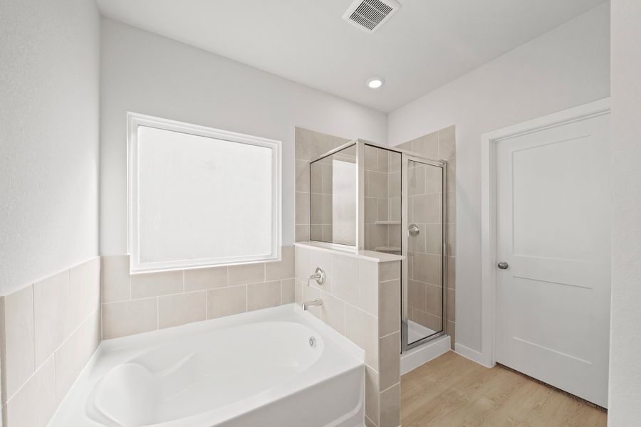 A bathroom with a tub and sink. A bathroom with a tub and sink.