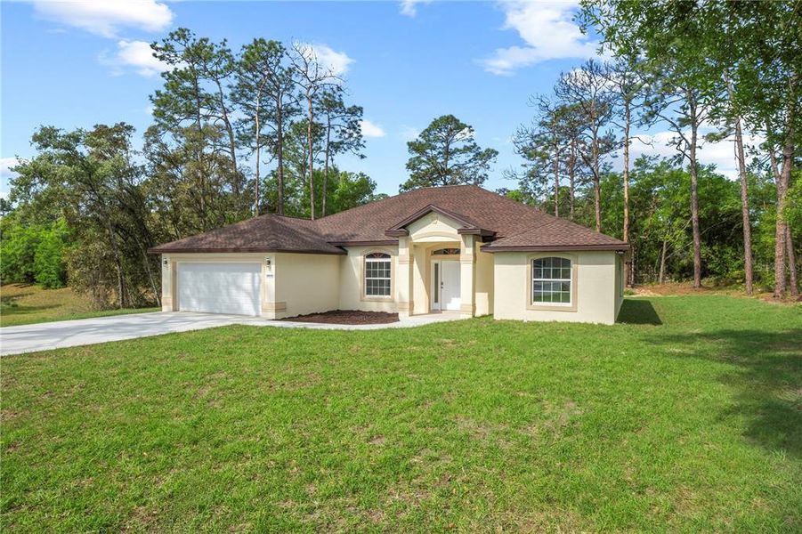Front exterior of a new home in , Dunnellon, FL, highlighting curb appeal (Image 1).