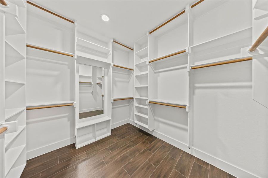 Walk in closet with wood finish floors Walk in closet with wood finish floors