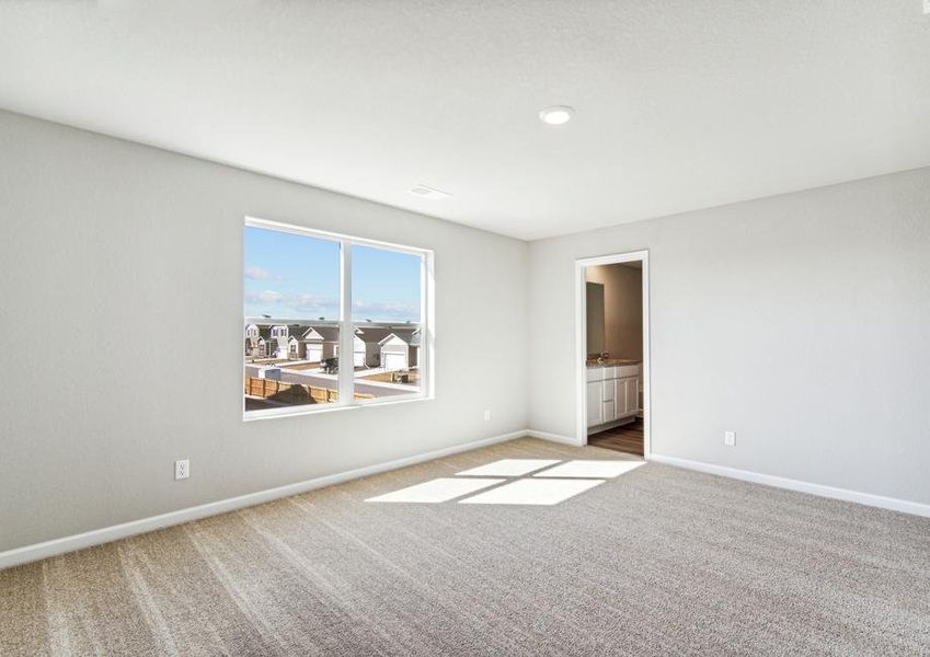 The master bedroom has a large window and carpet.