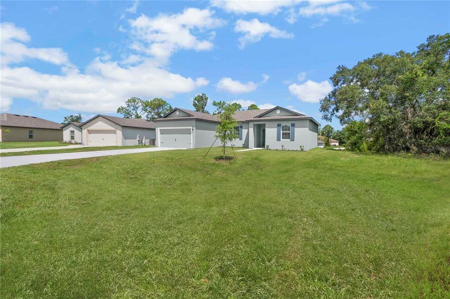 Front exterior of a new home in , Poinciana, FL, highlighting curb appeal (Image 1). Front exterior of a new home in , Poinciana, FL, highlighting curb appeal (Image 1).