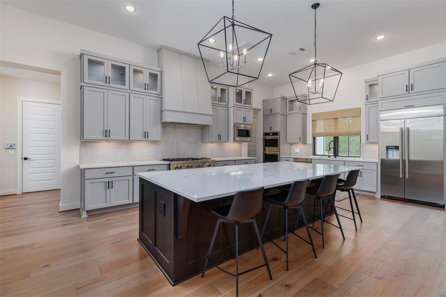 SS Double wall ovens, cabinet mounted microwave and dishwasher complete the professional grade kitchen appliances.  The large walk-in party to the right of the microwave has built in shelves for storage and power outlet for functionality.