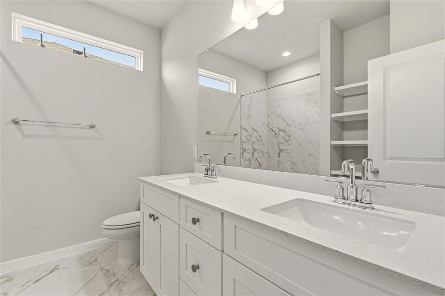 Full bath featuring double vanity, light marble finish floors, and a shower with curtain Full bath featuring double vanity, light marble finish floors, and a shower with curtain