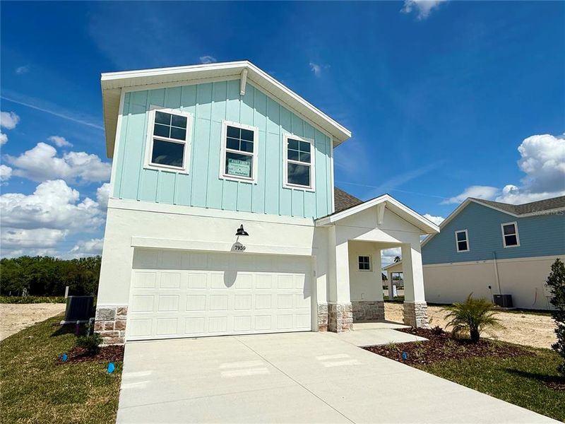 Front exterior of a new home in Emerald Fields, Hudson, FL, highlighting curb appeal (Image 1).