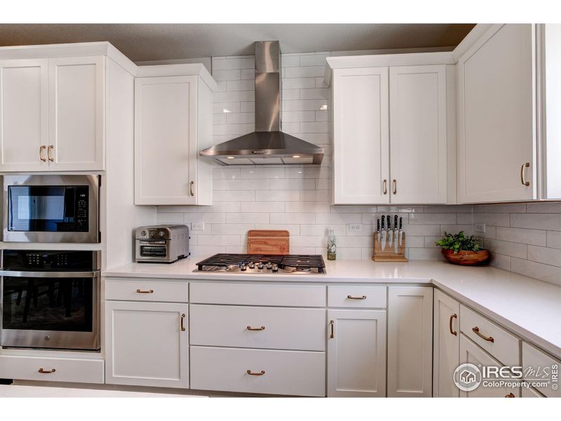 Upgraded cabinets with crown molding and custom hardware.
