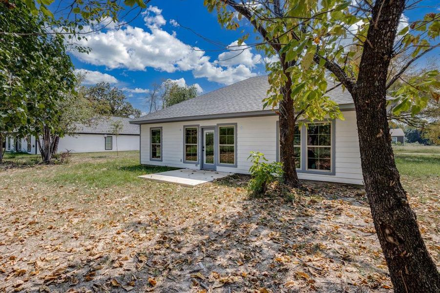 Back of property with a patio area and roof with shingles Back of property with a patio area and roof with shingles