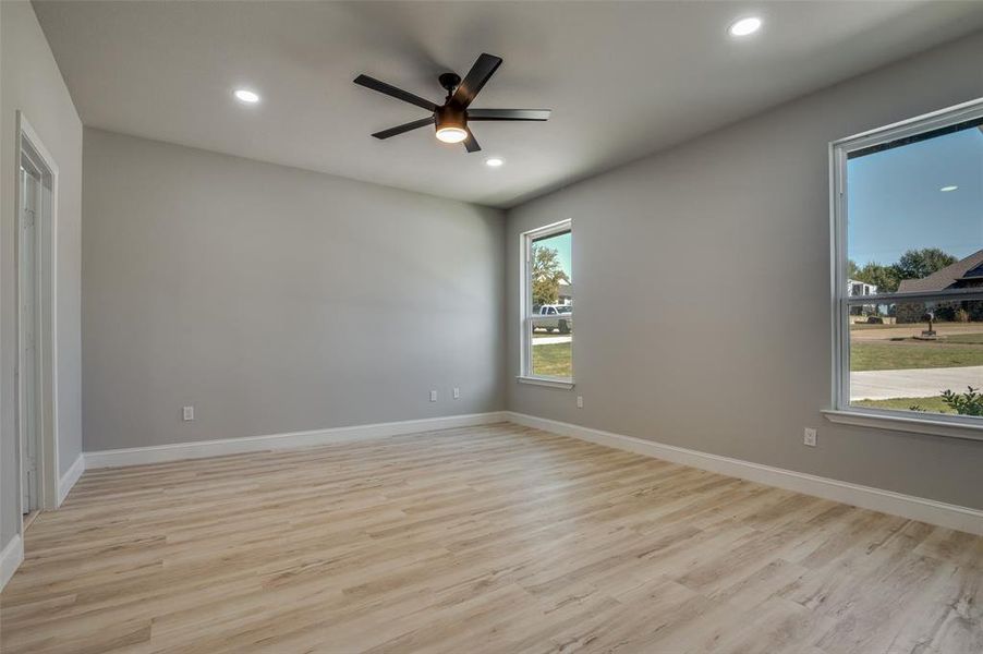 Unfurnished room featuring light wood-style flooring, recessed lighting, and a ceiling fan Unfurnished room featuring light wood-style flooring, recessed lighting, and a ceiling fan
