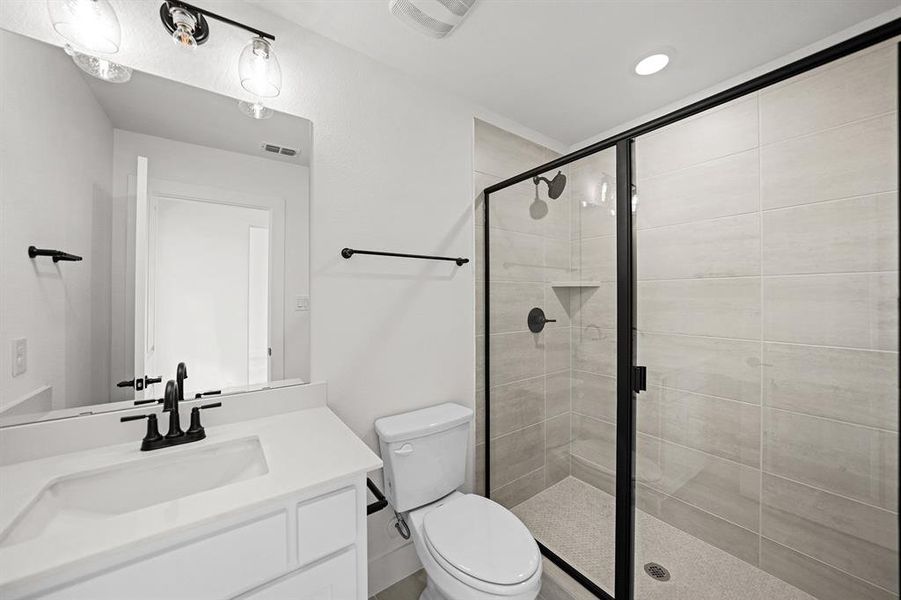 Full bathroom featuring vanity, a shower stall, and recessed lighting