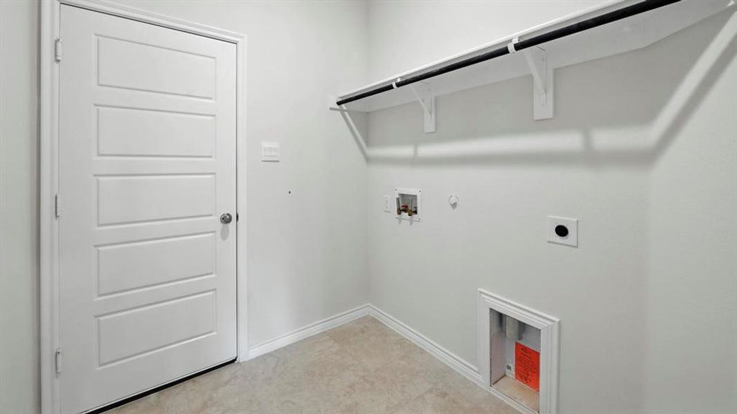 Laundry area featuring gas dryer hookup, electric dryer hookup, and hookup for a washing machine Laundry area featuring gas dryer hookup, electric dryer hookup, and hookup for a washing machine