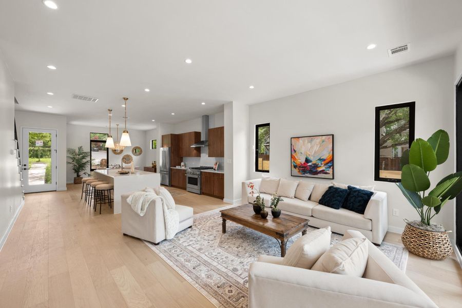 An open floorplan seamlessly connects the kitchen and living areas, offering effortless movement. An open floorplan seamlessly connects the kitchen and living areas, offering effortless movement.