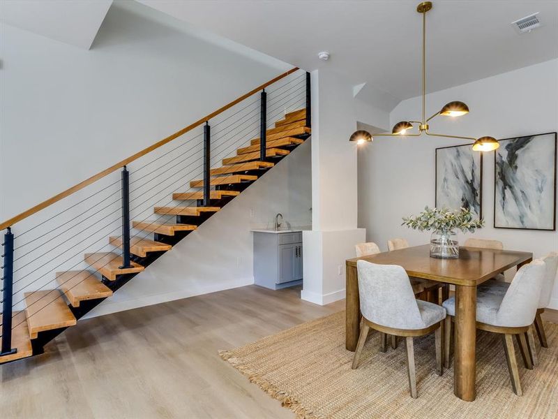 Open-tread staircase with wood planks and cable railing Open-tread staircase with wood planks and cable railing