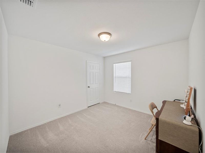 Office featuring light carpet, visible vents, and baseboards