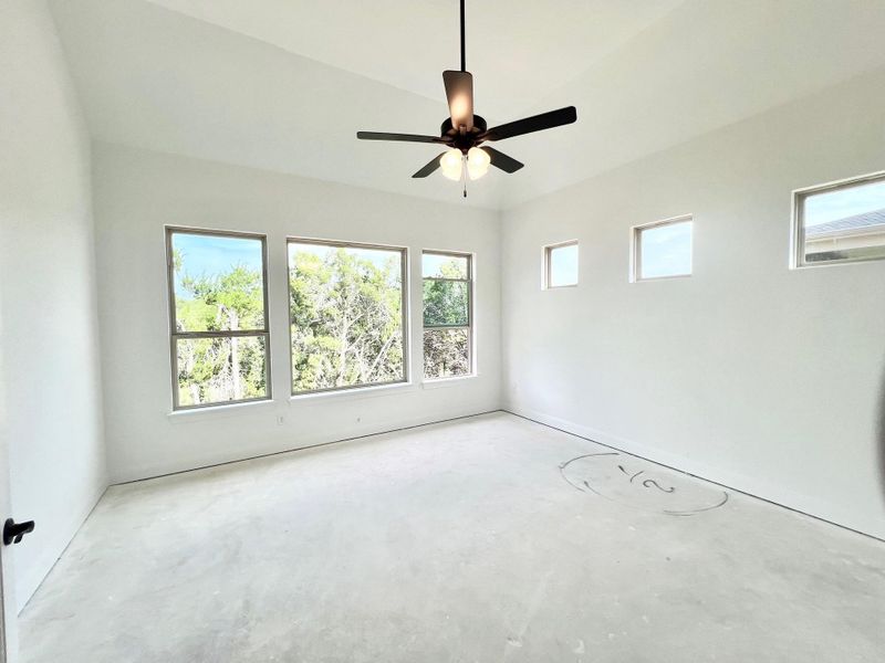 Spare room featuring unfinished concrete flooring and ceiling fan Spare room featuring unfinished concrete flooring and ceiling fan