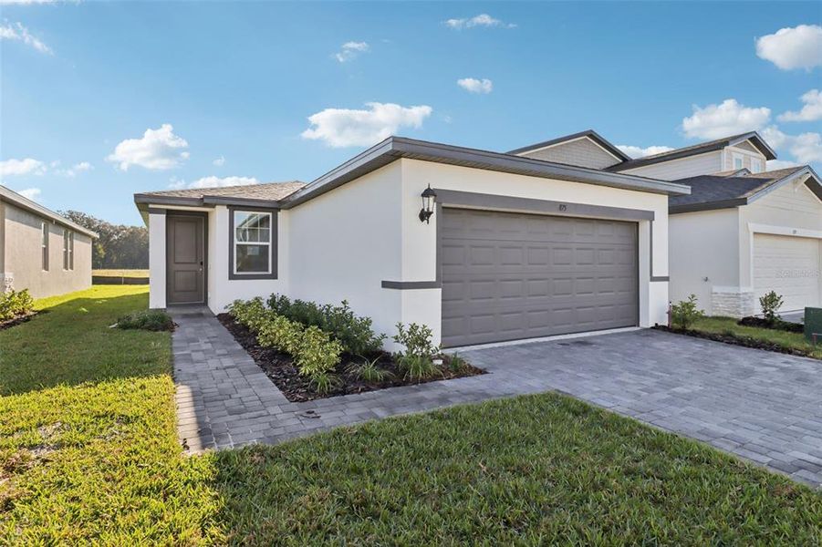 Front exterior of a new home in The Reserve at Hammock Oaks - Classic Series, Lady Lake, FL, highlighting curb appeal (Image 2). Front exterior of a new home in The Reserve at Hammock Oaks - Classic Series, Lady Lake, FL, highlighting curb appeal (Image 2).
