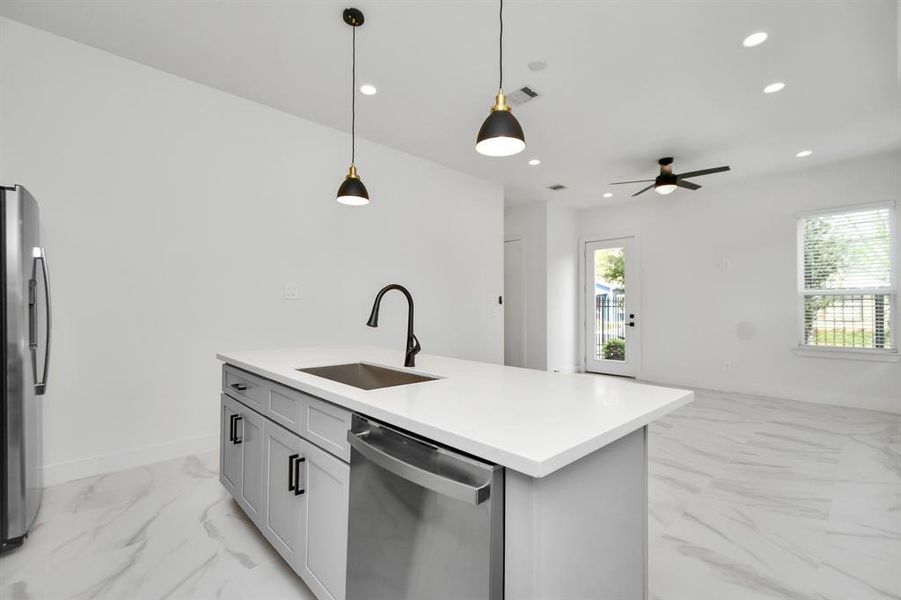 An open kitchen layout that facilitates seamless interaction between the cooking, dining and living spaces