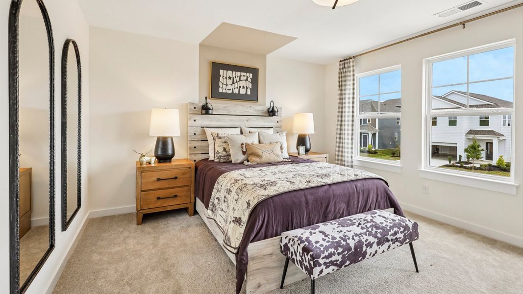 Secondary bedroom with carpet, closet, and window