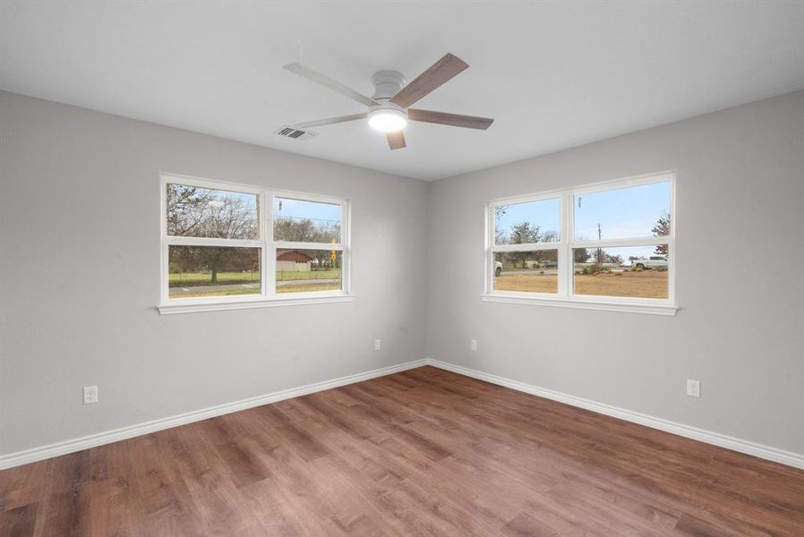 Empty room featuring hardwood / wood-style floors and ceiling fan Empty room featuring hardwood / wood-style floors and ceiling fan