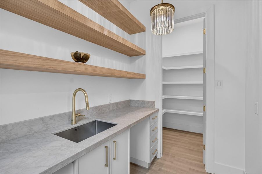The spacious butler's pantry offers additional storage, prep space, and seamless convenience when entertaining guests. The spacious butler's pantry offers additional storage, prep space, and seamless convenience when entertaining guests.