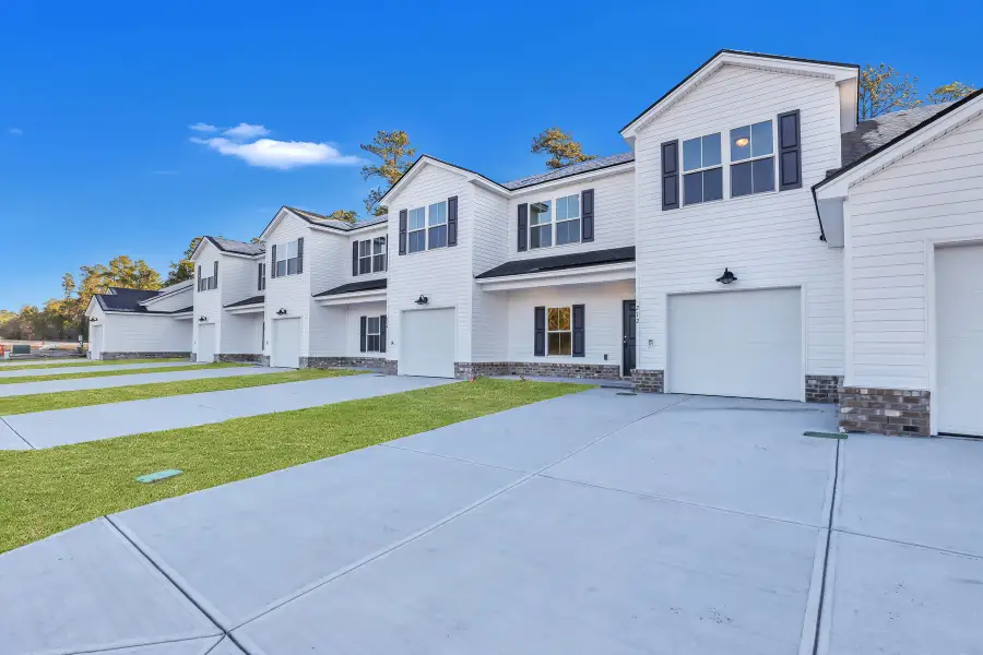 Front exterior of a new home in New Haven At Belmont Glen, Guyton, GA, highlighting curb appeal (Image 2).