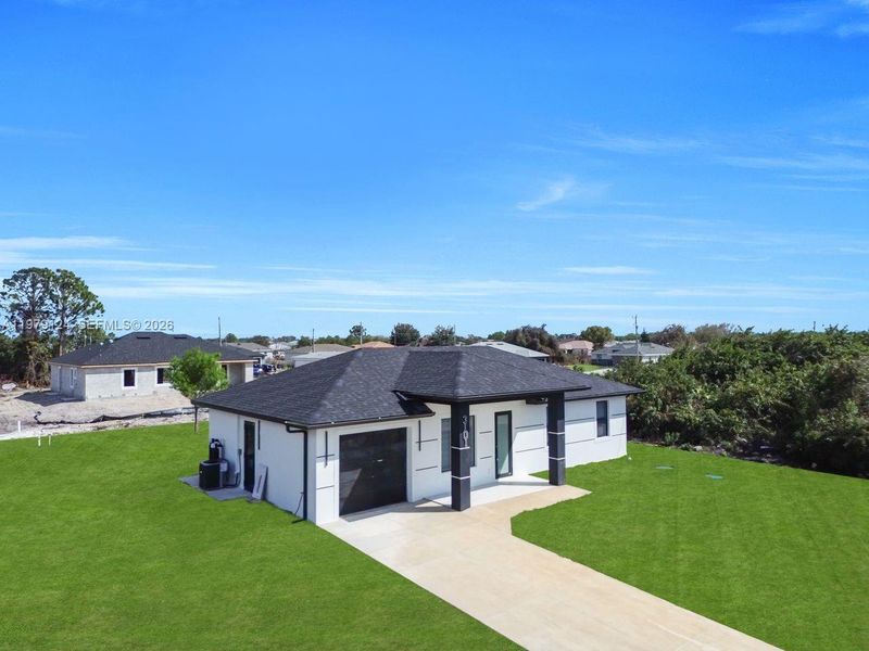 Front exterior of a new home in , Lehigh Acres, FL, highlighting curb appeal (Image 24).