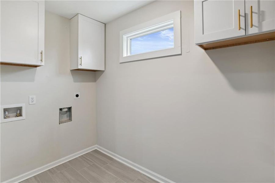 Laundry room featuring cabinets, electric dryer hookup, and washer hookup