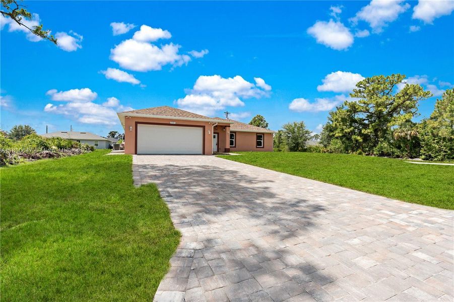 Front exterior of a new home in , Lehigh Acres, FL, highlighting curb appeal (Image 13).