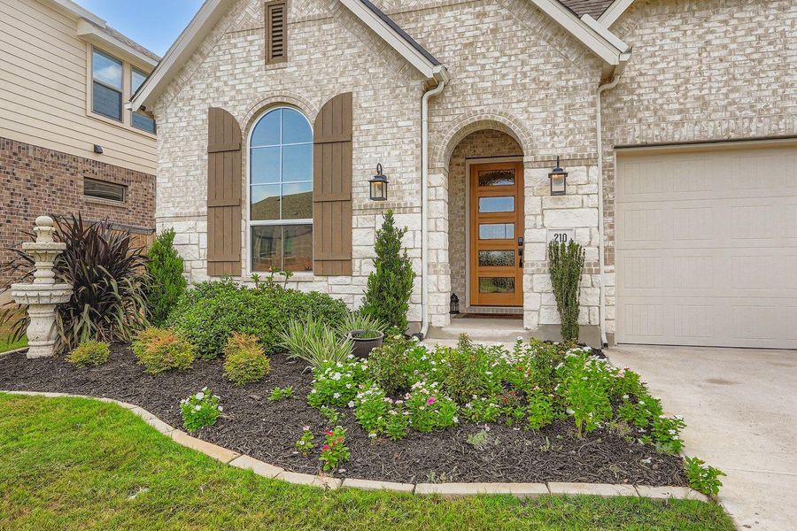 Front exterior of a new home in 6 Creeks at Waterridge: 55ft. lots, Kyle, TX, highlighting curb appeal (Image 20).