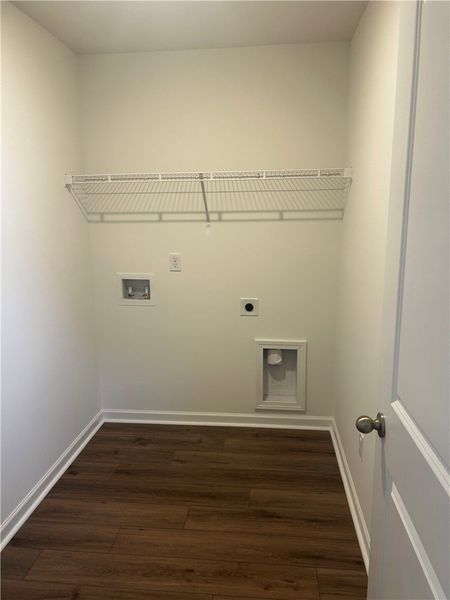Functional laundry room featuring sturdy wood floo