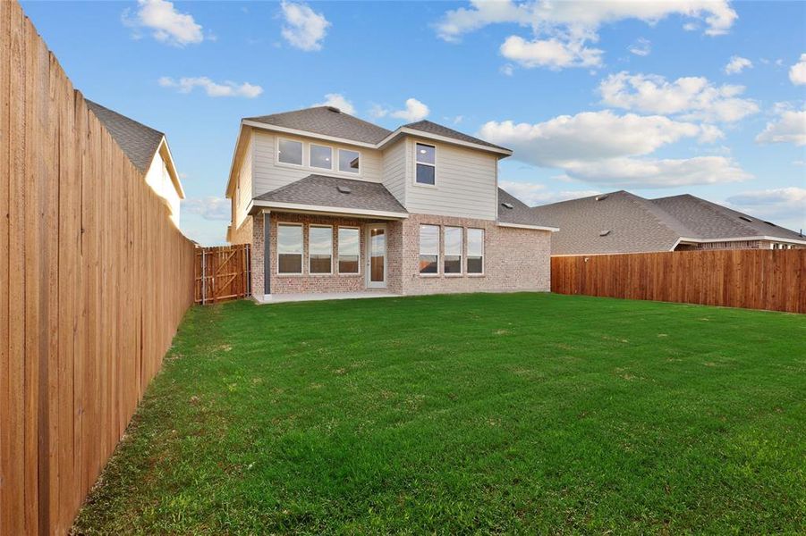 Back of property featuring brick siding and roof with shingles Back of property featuring brick siding and roof with shingles