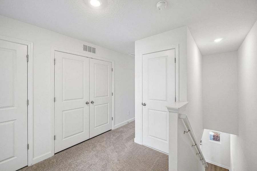 The upstairs loft guides you into the bedroom spaces