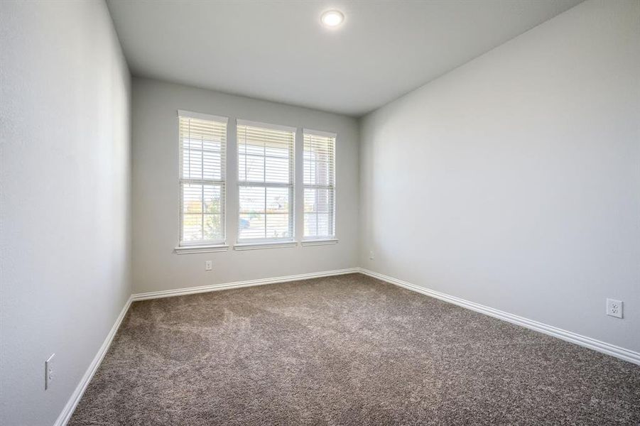 Unfurnished room featuring carpet flooring and baseboards Unfurnished room featuring carpet flooring and baseboards