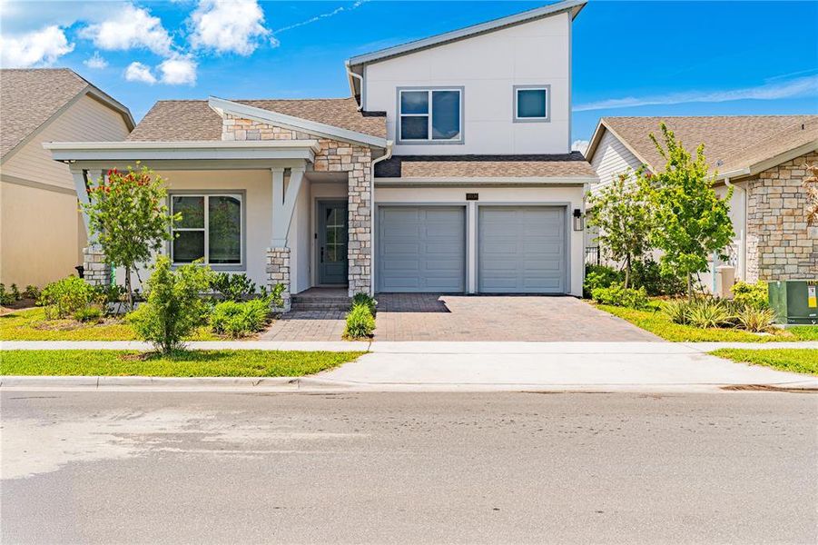 Front exterior of a new home in Laureate Park (Craft Homes), Orlando, FL, highlighting curb appeal (Image 21). Front exterior of a new home in Laureate Park (Craft Homes), Orlando, FL, highlighting curb appeal (Image 21).