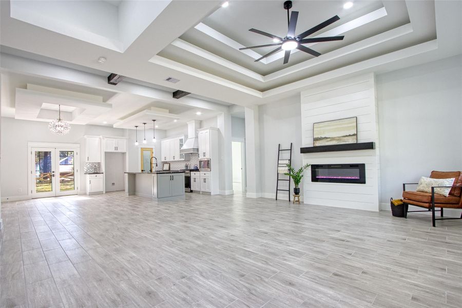 Spacious open floor plan with large electric fireplace and gorgeous tray ceilings!