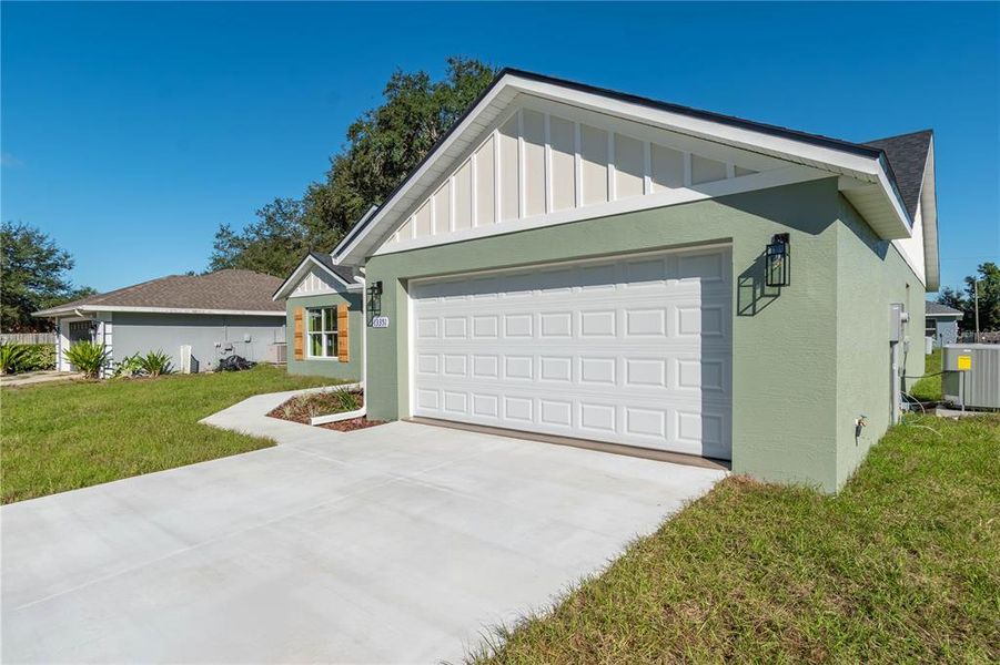 Front exterior of a new home in , Dunnellon, FL, highlighting curb appeal (Image 2).