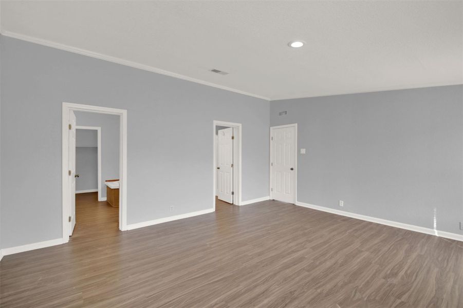 Spare room with light wood-style floors, recessed lighting, and crown molding
