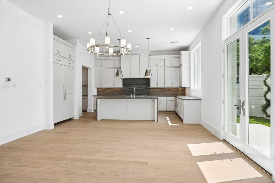 Dining space is located directly off of the living. Ample windows and a set of French doors fill this space with light.