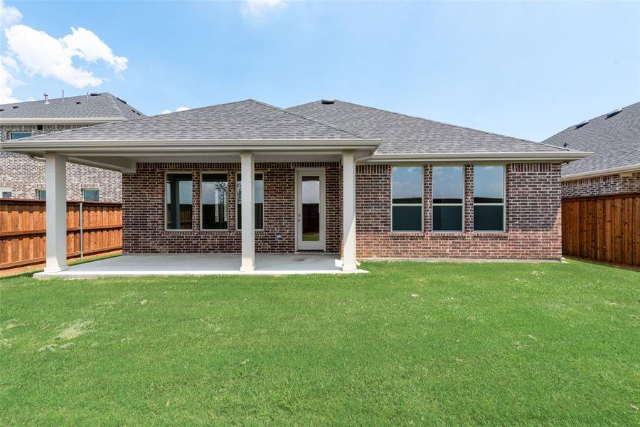 Front exterior of a new home in Spiritas Ranch, Little Elm, TX, highlighting curb appeal (Image 18). Front exterior of a new home in Spiritas Ranch, Little Elm, TX, highlighting curb appeal (Image 18).