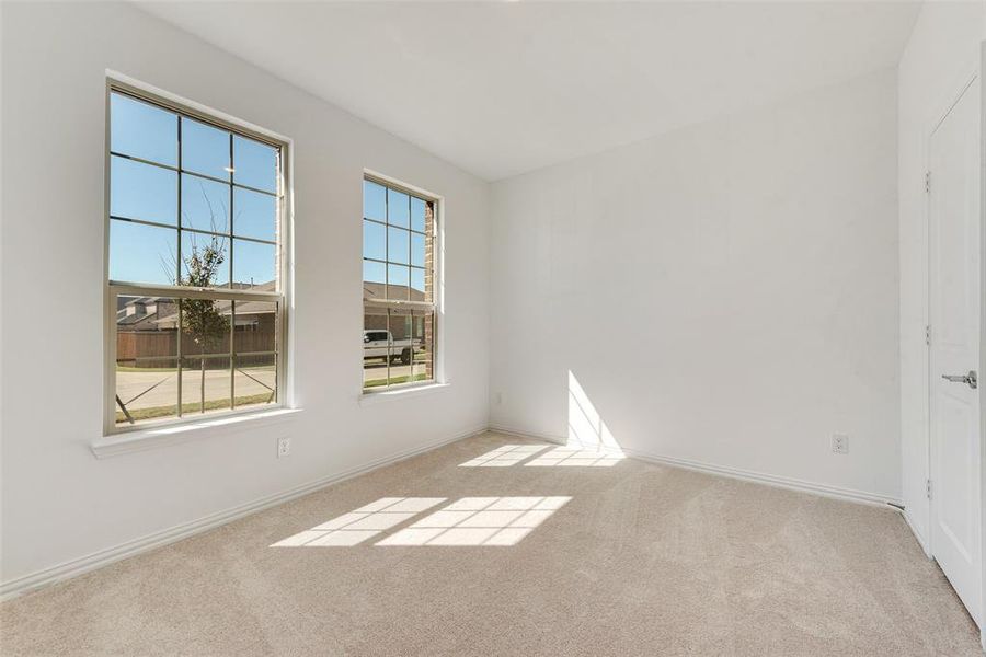 Empty room featuring light colored carpet