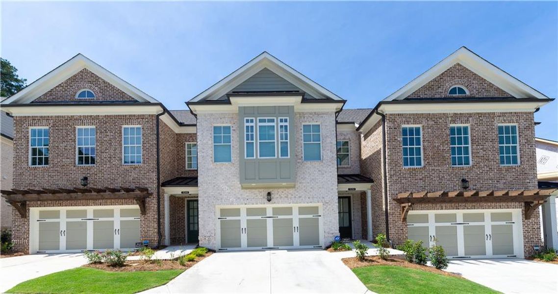 Front exterior of a new home in Waterside Townhomes, Peachtree Corners, GA, highlighting curb appeal (Image 1). Front exterior of a new home in Waterside Townhomes, Peachtree Corners, GA, highlighting curb appeal (Image 1).
