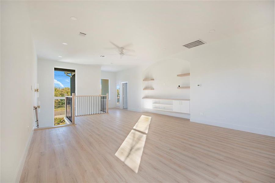 Spare room with light wood-type flooring, ceiling fan, and recessed lighting Spare room with light wood-type flooring, ceiling fan, and recessed lighting